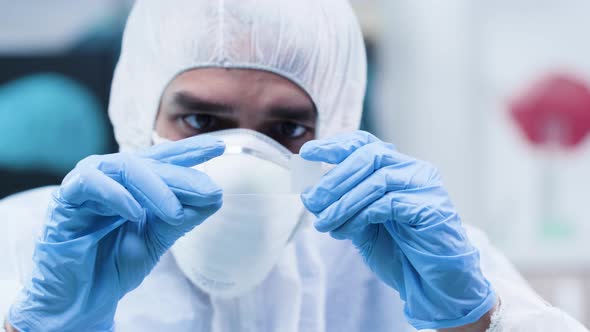 Close Up Shot of Scientist in White Coverall Looking at a Sample alt