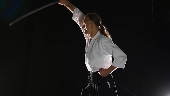 Man Fighting at Aikido Training with Japanese Sword Katana in Martial Arts School. Healthy Lifestyle alt