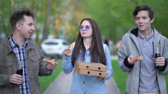 People Eat Pizza and Walk Around the City
