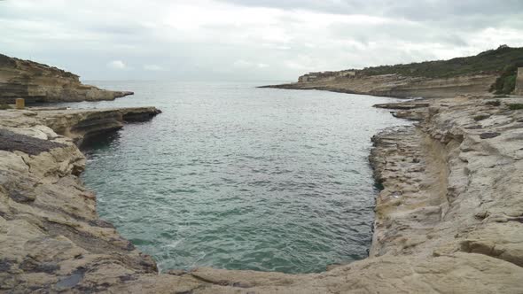 Il-Kalanka Beach in Malta With Calm Mediterranean Sea on Cloudy Day in Winter
