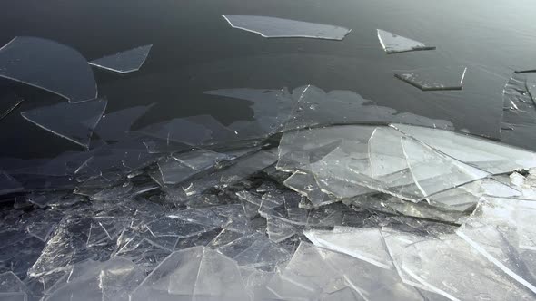 Sheets of ice shifting on frozen lake as the surface moves in winter ...