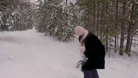 Carefree Mom and Daughter Playing To Snow Fight in Winter Forest Slow Motion alt