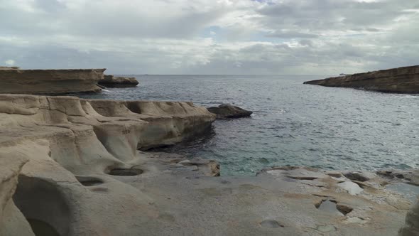 Walking on St Peters Pool Beach on a Cloudy Winter Day in Malta alt