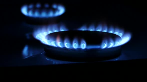Gas ring flame, gas stove burners in the dark turned on and off alt