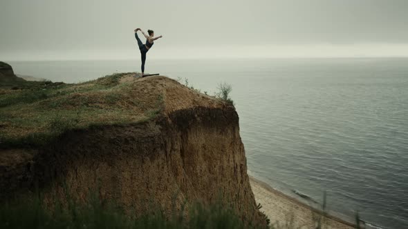 Athlete Woman Streching Holding Leg on Beach Hill alt