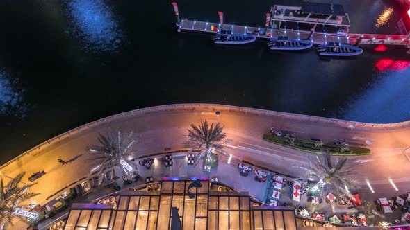 Promenade and Canal in Dubai Marina with Luxury Skyscrapers and Yachts Around Night Timelapse United alt