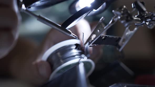 Unrecognized Successful Man Working with a Soldering Iron at His Working Place. Concept of the alt