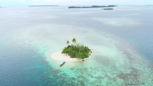 Aerial: flying over desert island tropical beach caribbean sea coral reef sunset alt