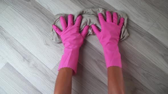 Women's Gloved Hands with a Rag Wash the Floor