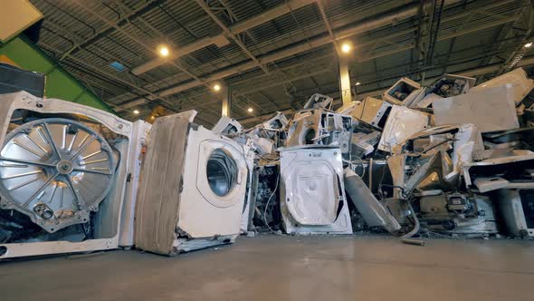 Waste, Plastic Trash, Garbage Recycling Plant. Landfill Unit with a Pile of Broken Washing Machines alt