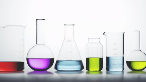 Laboratory glassware with colorful liquids inside on a light background looping. alt
