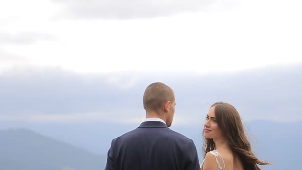 Happy Brides Bride and Groom Overlooking Beautiful Green Mountains alt