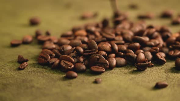 Roasted coffee beans falling down in golden light alt