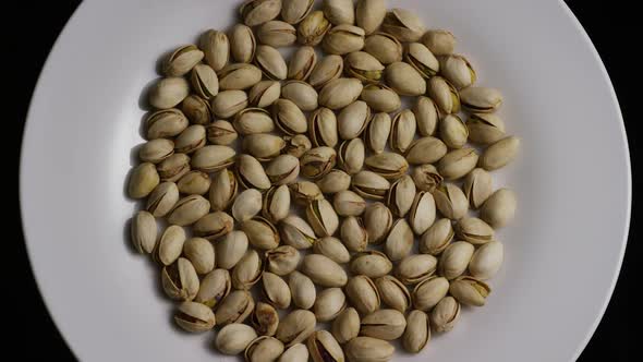 Cinematic, rotating shot of pistachios on a white surface - PISTACHIOS 001 alt