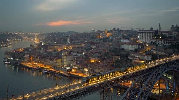 Evening Porto with Dom Luis I Bridge Over Douro River, People Walking Along the Illuminated Bridge alt