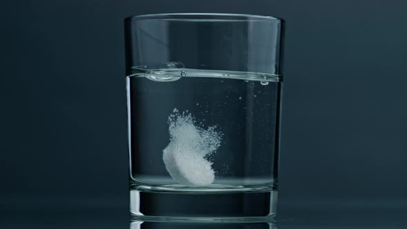 Closeup Tablet Dropped Glass at Dark Background alt