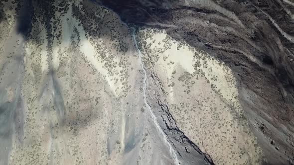 Overhead aerial drone clip over a mountainous barren volcanic area / 6  Full Hd