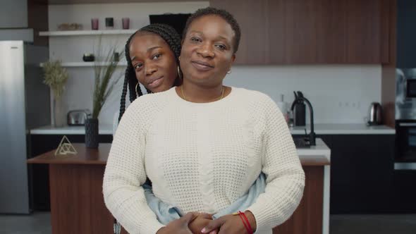 Happy African Mother and Daughter Smiling Indoors alt