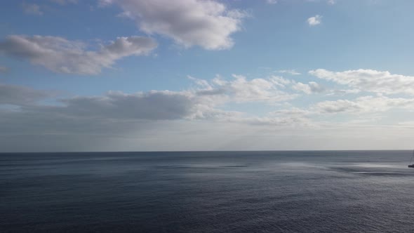Aerial View From Above on Calm Azure Sea and Volcanic Rocky Shores alt