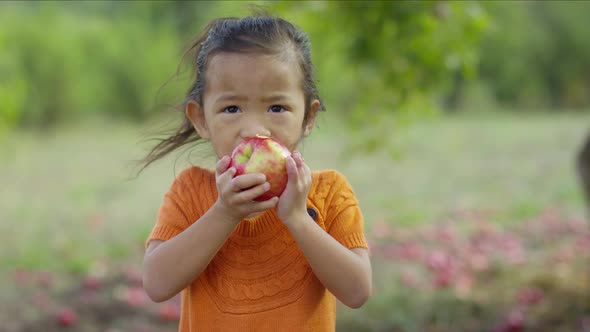Young girl in Fall eating apple