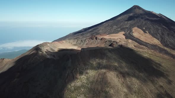 Aerial drone clip over the top of a volcano with clouds leaving shadows 14 4K