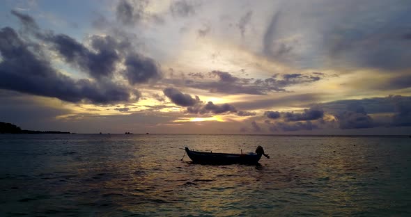 Wide flying copy space shot of a white sand paradise beach and aqua blue water background in 4K alt