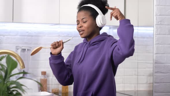 African American Black Handsome Woman Cooking Dancing with Headphones Enjoy Life Listening Favourite alt