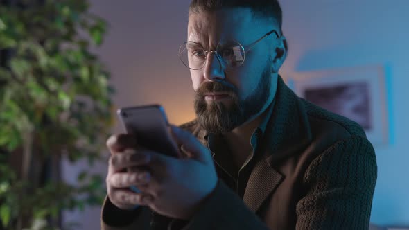 Man Using Smartphone Indoors