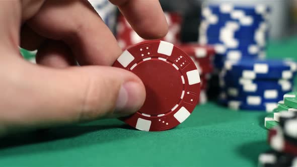 Hand With Red Poker Chips
