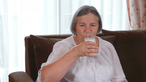 Healthy Senior Lady Drinking Milk