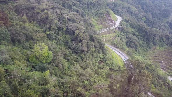 Aerial shot road in Green Mountain Hills, Deep Forest Tree Landscape Curved Road Aerial View