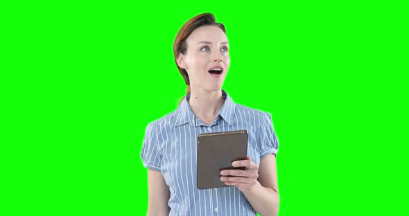 Caucasian woman using a digital tablet on green background