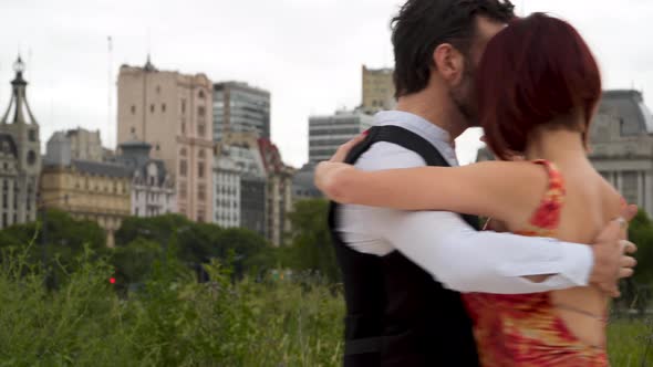 A couple of tango performers dancing closely while holding hands passionately in Downtown Buenos Air alt