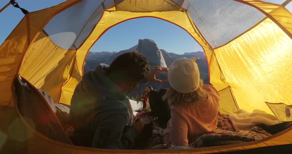 A Hand Heart Made By a Couple, Relaxing in a Tent, Against the View of Half Dome Mountain. Yosemite. alt