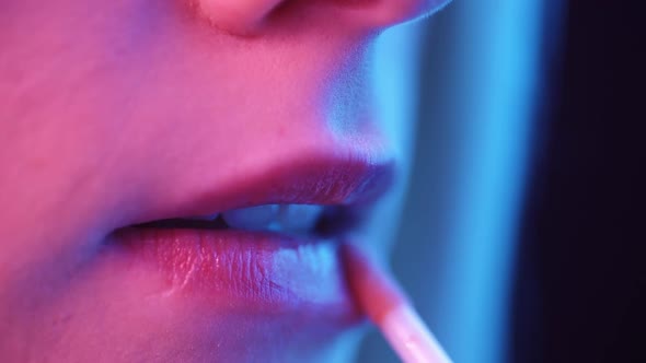 Sexy Female Lips in Neon Light Closeup alt