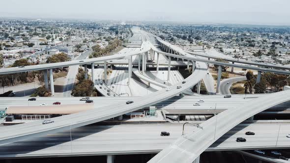 Drone Moving Backwards Over Huge Freeway Intersection in Los Angeles alt