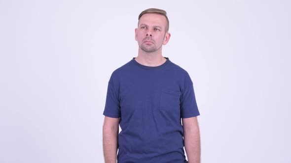 Portrait of Happy Blonde Man Smiling and Waving Hand alt