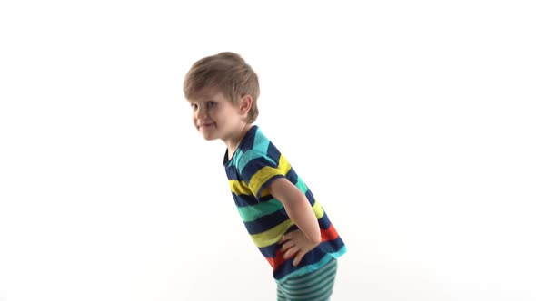 Little Boy in the Studio on a White Background Dancing Funny Dance