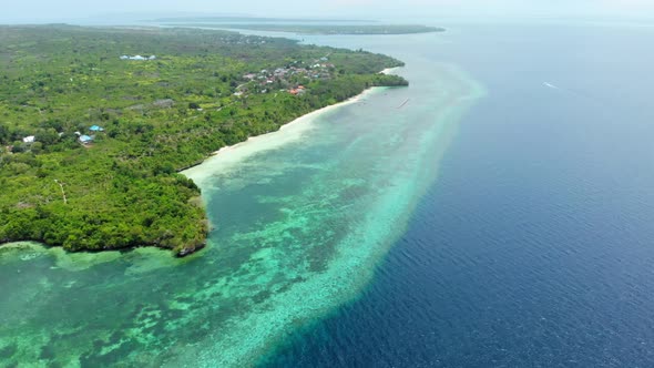 Aerial: Flying over tropical beach turquoise water coral reef , Tomia island Wak alt