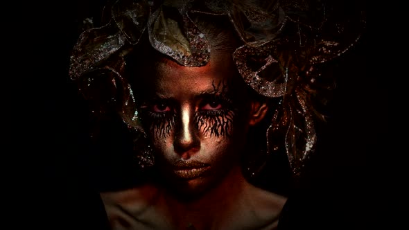 Fantasy. Creative Art Project. Golden Young Woman. Halloween Female Model, Face in Gold. Halloween alt