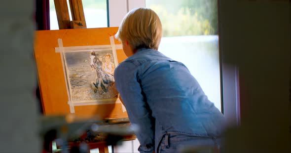 Female painter painting on a canvas at home 4k