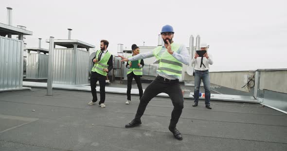 An Architecture Fine Man Dances in Front of His Worker Friends alt