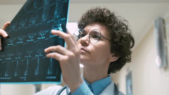 Female surgeon examining X-ray pictures