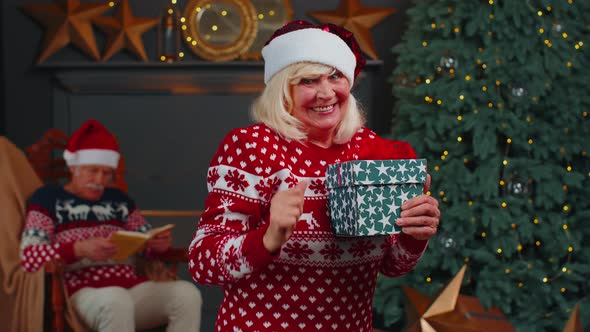 Senior Grandmother in Christmas Sweater Celebrate Success Win Scream Doing Winner Hands Gesture alt