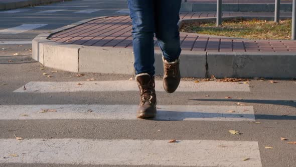 A Woman in Brown Shoes Crosses the Road at a Pedestrian Crossing Legs Closeup alt