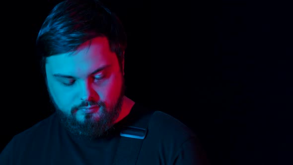 A Trio of Guitarists Perform the Composition on Their Instruments in the Studio Against a Black alt