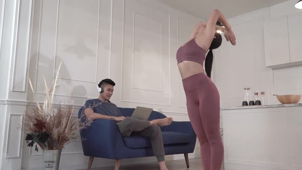 Asian woman practicing yoga in the living room