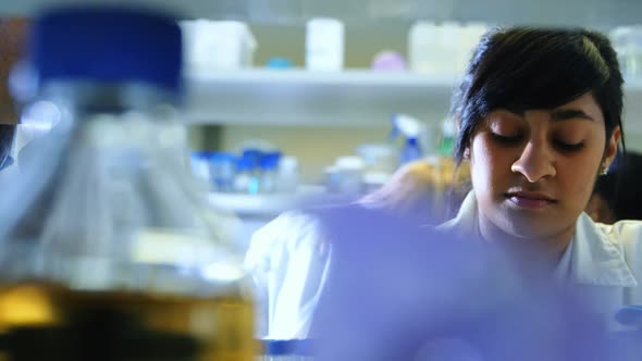 Scientist experimenting in laboratory 4k alt