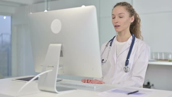 Portrait of Young Female Doctor Doing Video Chat on Desk Top alt