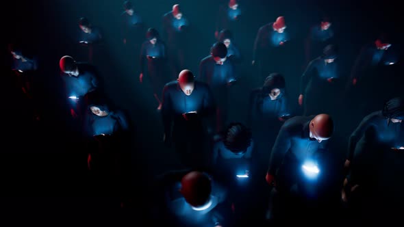 People hypnotized by their mobiles walk in the dark. Zombie walk.  Mind control alt